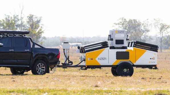 A car with a hitched trailer, which is carrying the HubX drone-in-a-box system.