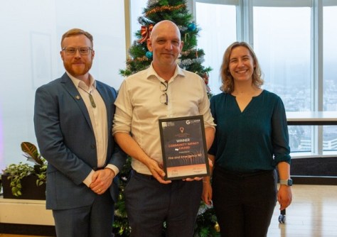 Three people standing with an awards trophy at the Spatial Excellence Awards