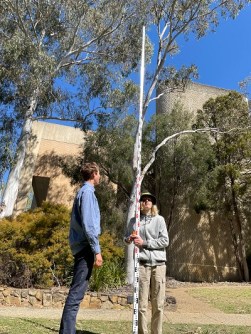 Two high-school students operating a surveying instrument during the Let's Locate surveying immersion program