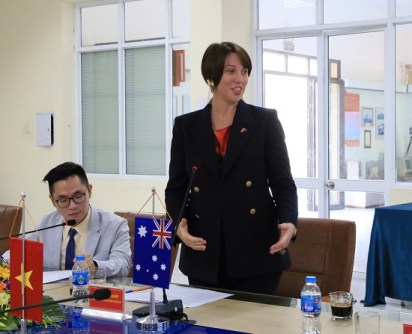 Renee Deschamps, standing at a table and speaking during the hydrographic training graduation ceremony