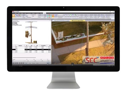 A picture of a computer screen showing a reality capture point cloud image of a footpath surrounded by grass areas, seen from above