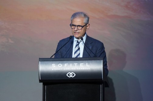 Professor Andy Koronios standing at a lectern, announcing the ASII
