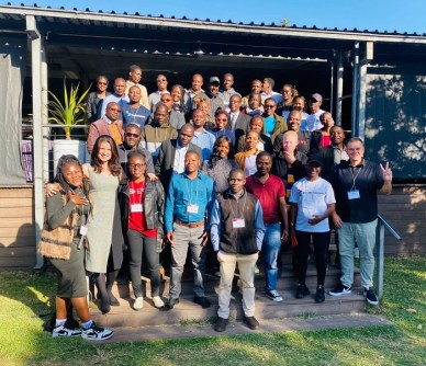 A group of people standing in front of a building, having conducted a sustainable development mapping workshop