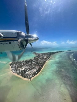 A view out the window of a light aircraft as it flies above Tarawa in Kiribati