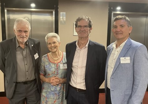 Four people standing side by side in a room at the launch of the scholarship