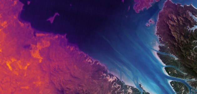 Satellite image of a bay with land on the left and the right, with small rivers leading into the bay. The image was product by Hydrosat, which has just acquired new funding.