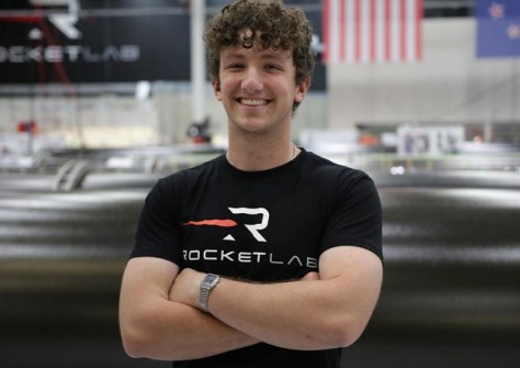 Liam Heffernan, wearing a Rocketlab t-shirt, standing with his arms crossed.