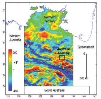 A magnetic map of the Northern Territory, in false colour, greens, blues, reds and yellows, with the location of the Australia Magnetic Anomaly marked at centre right.