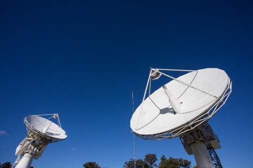 Two satellite dishes in one frame, pointed at the sky, used for the SouthPAN project run by Geoscience Australia and LINZ