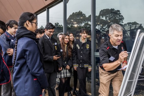 School students being given a demonstration of surveying techniques