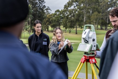 An instructor demonstrating how to use a total station