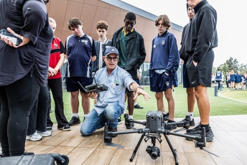 Students being shown how a drone works in surveying