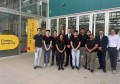 A dozen people, including some from AICRAFT, standing outside a building