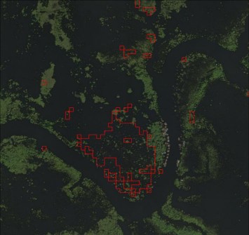 A satellite image of forest with markers showing false detections of deforestation