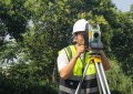 A man looking through a SingularXYZ total station