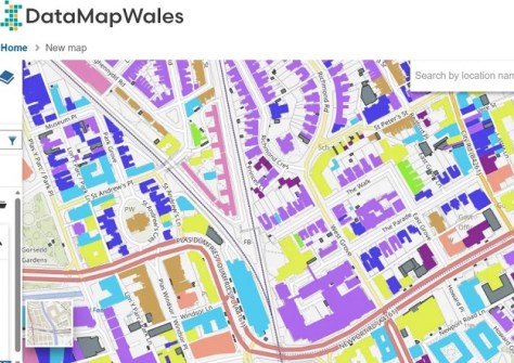 A DataMapWales screenshot showing an overhead-view map of streets, with buildings marked in different colours