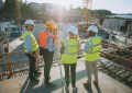 Four surveyors on a building site