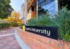 A Curtin University building with a Curtin University sign on its front
