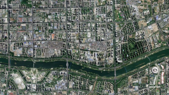 A satellite Pelican image of Taiyuan in China, showing a red plain against a mountain range, with a small city