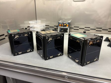 Three Binar CubeSat satellites on a bench