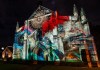 A church colourfully lit up at night using laser and LED displays during the Vivid festival