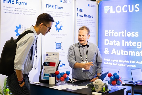 Two men discussing a product at a exhibition stand at Locate