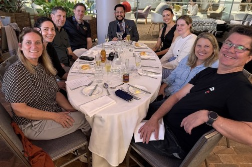 A group of people sitting at a dinner table at a restaurant