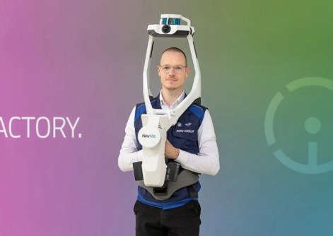 A man wearing a NavVis mobile laser scanning device