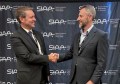 Planet’s Jake Ramsay (left) and Nova Systems’ Dean Rosenfield shake hands a the signing of the situational awareness deal