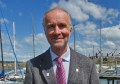 A head-and-shoulders image of Dr Peter Knight with a yacht harbour in the background