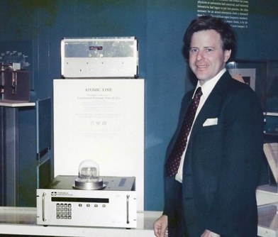 A photograph of Charlie Trimble standing next to a GPS receiver