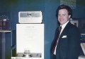A photograph of Charlie Trimble standing next to a GPS receiver