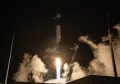 A rocket launching at night time, carrying an Earth observation satellite