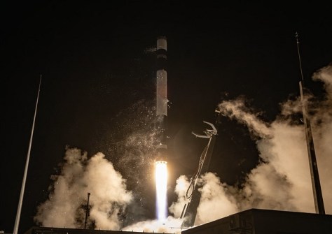 A rocket launching at night time, carrying an Earth observation satellite