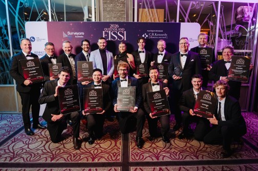 A group of about 15 people in evening dress, holding Queensland EISSI award certificates