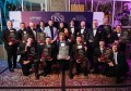 A group of about 15 people in evening dress, holding Queensland EISSI award certificates
