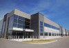 An outdoor, sunny day photo of a modern industrial estate building
