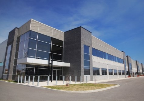 An outdoor, sunny day photo of a modern industrial estate building