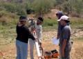Four people using a total station in Timor-Leste